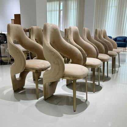 Luxury sculptural velvet chair with openwork curved gold legs - designer chair