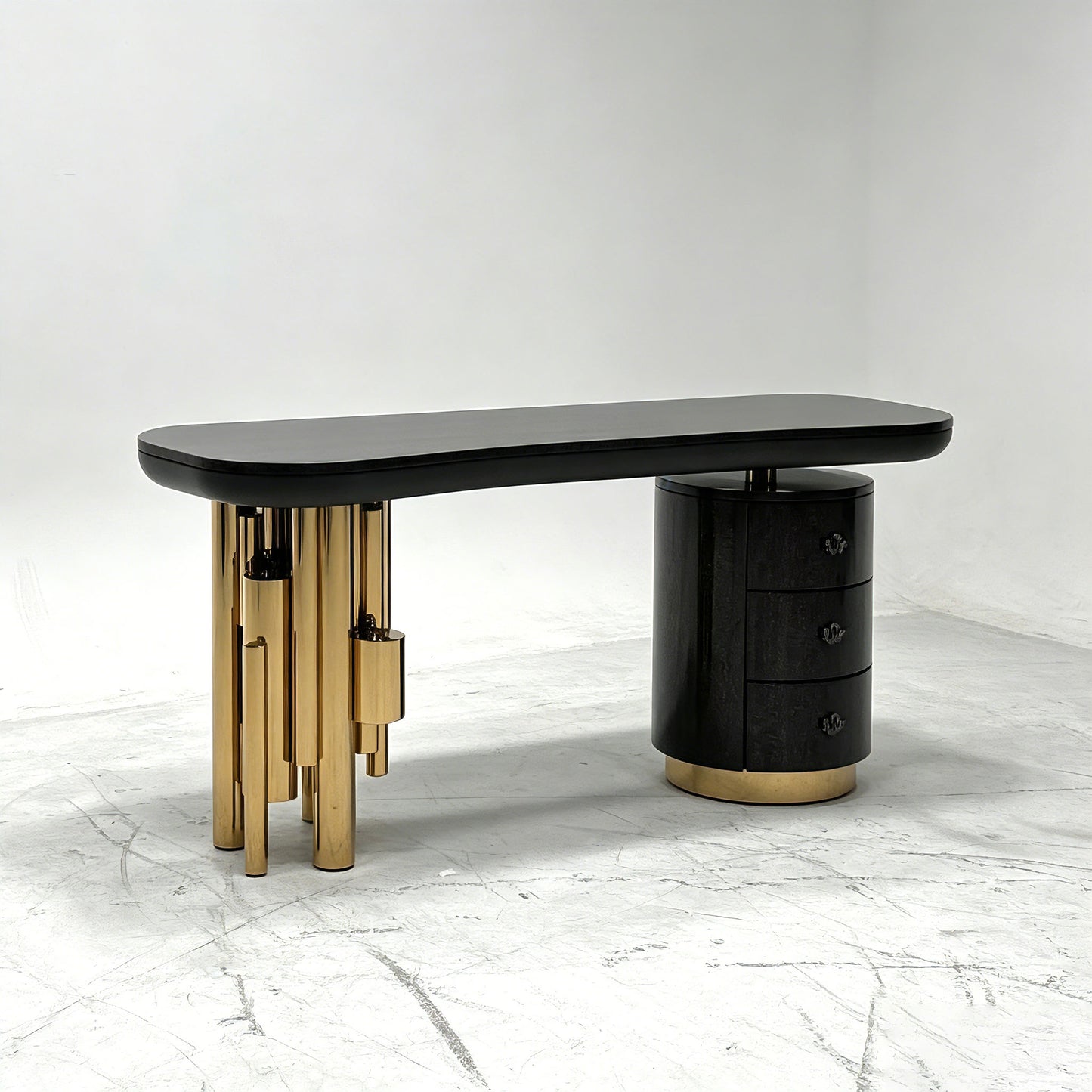Antigua sculptural luxury desk featuring gold tubular legs and serpentine handles