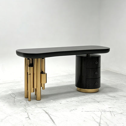 Antigua sculptural luxury desk featuring gold tubular legs and serpentine handles